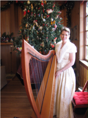 Harpist Anne Roos Next to a Christmas Tree