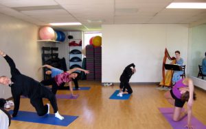 Harpist Anne Roos plays live for Pilates class