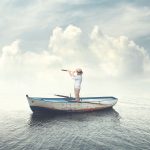 person on a boat searching with binoculars